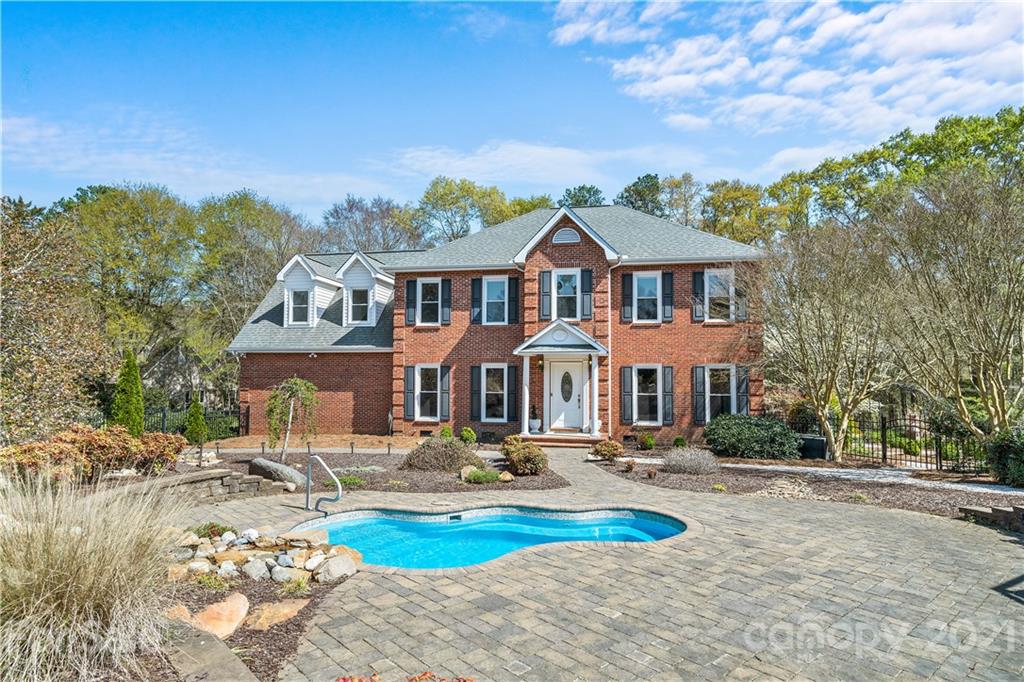 8866 Collins Road Indian Land, SC 29707 - Photo 32 of 48 a front view of a house with swimming pool yard and outdoor seating