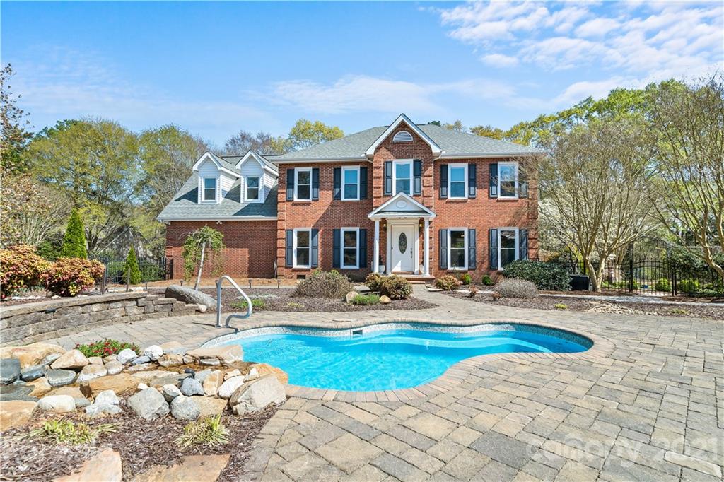 8866 Collins Road Indian Land, SC 29707 - Photo 35 of 48 a front view of a house with swimming pool and porch