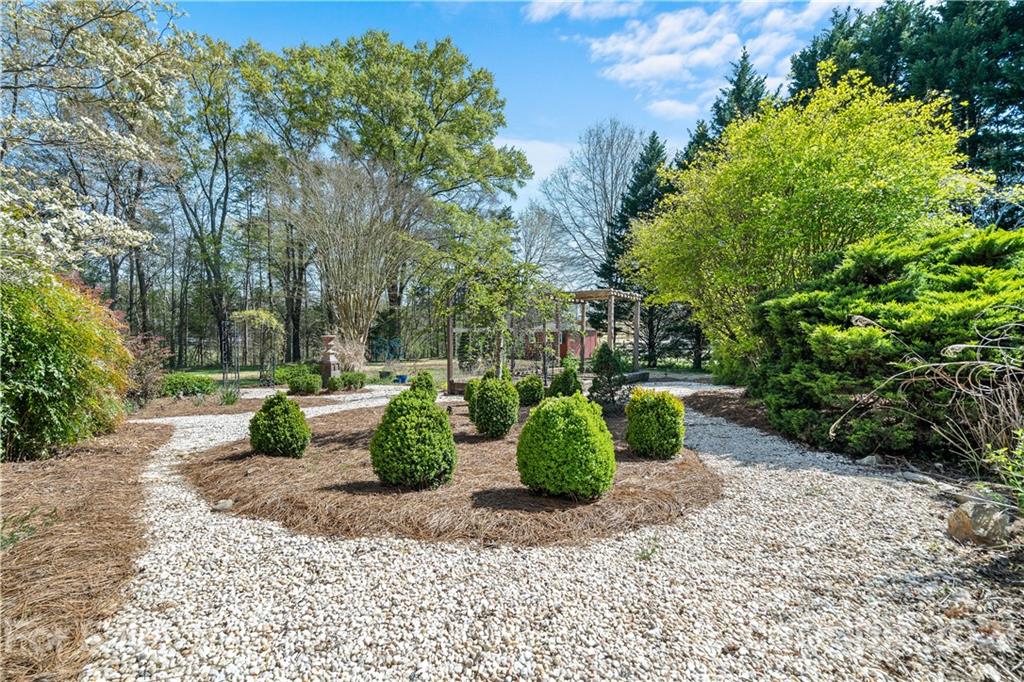 8866 Collins Road Indian Land, SC 29707 - Photo 37 of 48 a view of a backyard with sitting area and garden