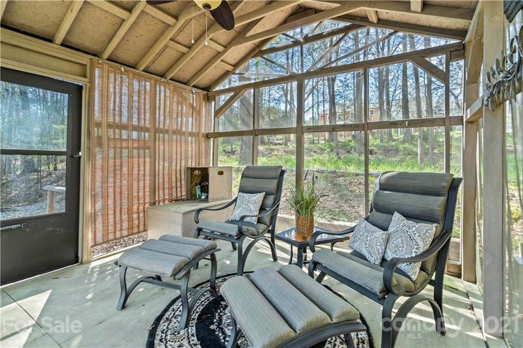 8866 Collins Road Indian Land, SC 29707 - Photo 41 of 48 a living room with furniture and a floor to ceiling window
