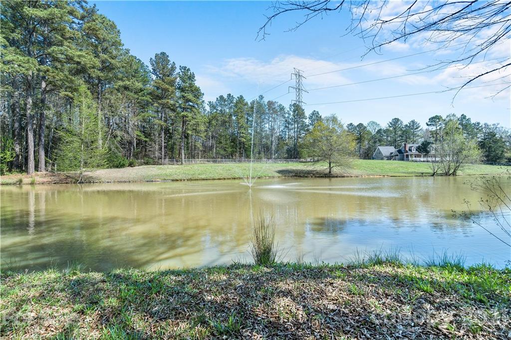 8866 Collins Road Indian Land, SC 29707 - Photo 44 of 48 a view of a lake with a yard