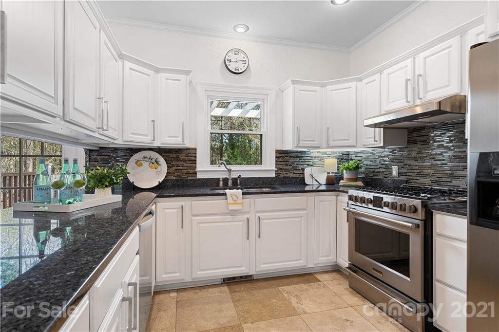 8866 Collins Road Indian Land, SC 29707 - Photo 7 of 48 a kitchen with granite countertop a stove and a sink