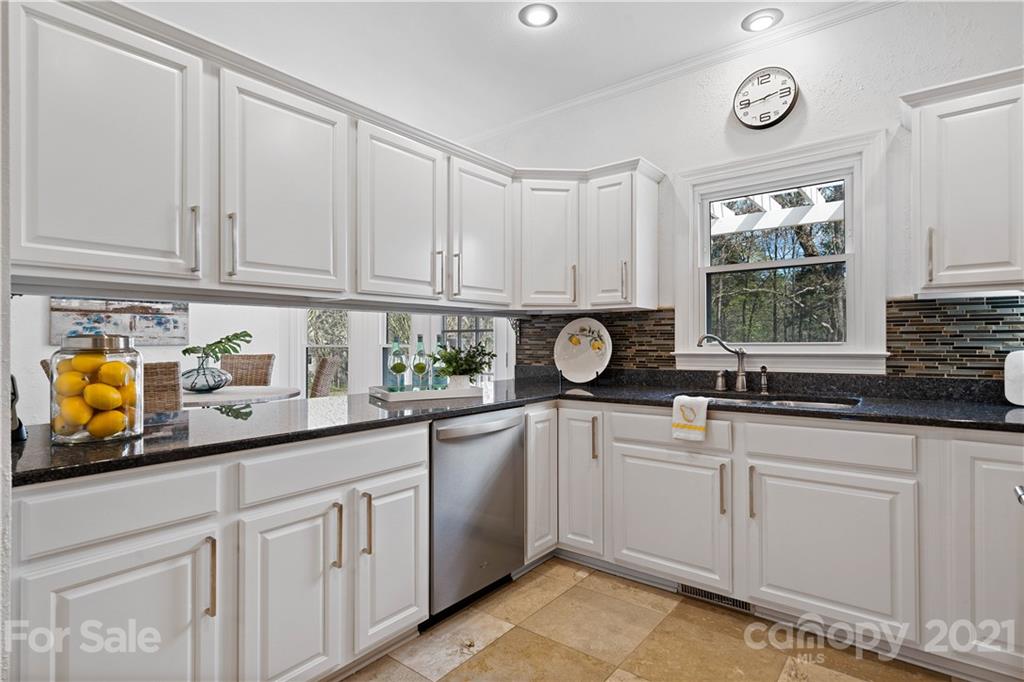 8866 Collins Road Indian Land, SC 29707 - Photo 8 of 48 a kitchen with white cabinets and white appliances