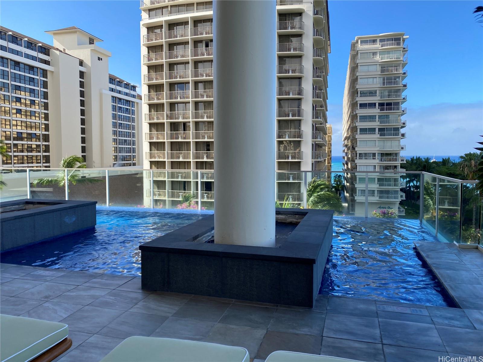 223 Saratoga Road, Unit 2220 Honolulu, HI 96815 - Photo 15 of 15 a view of a roof deck with couches and potted plants with wooden floor