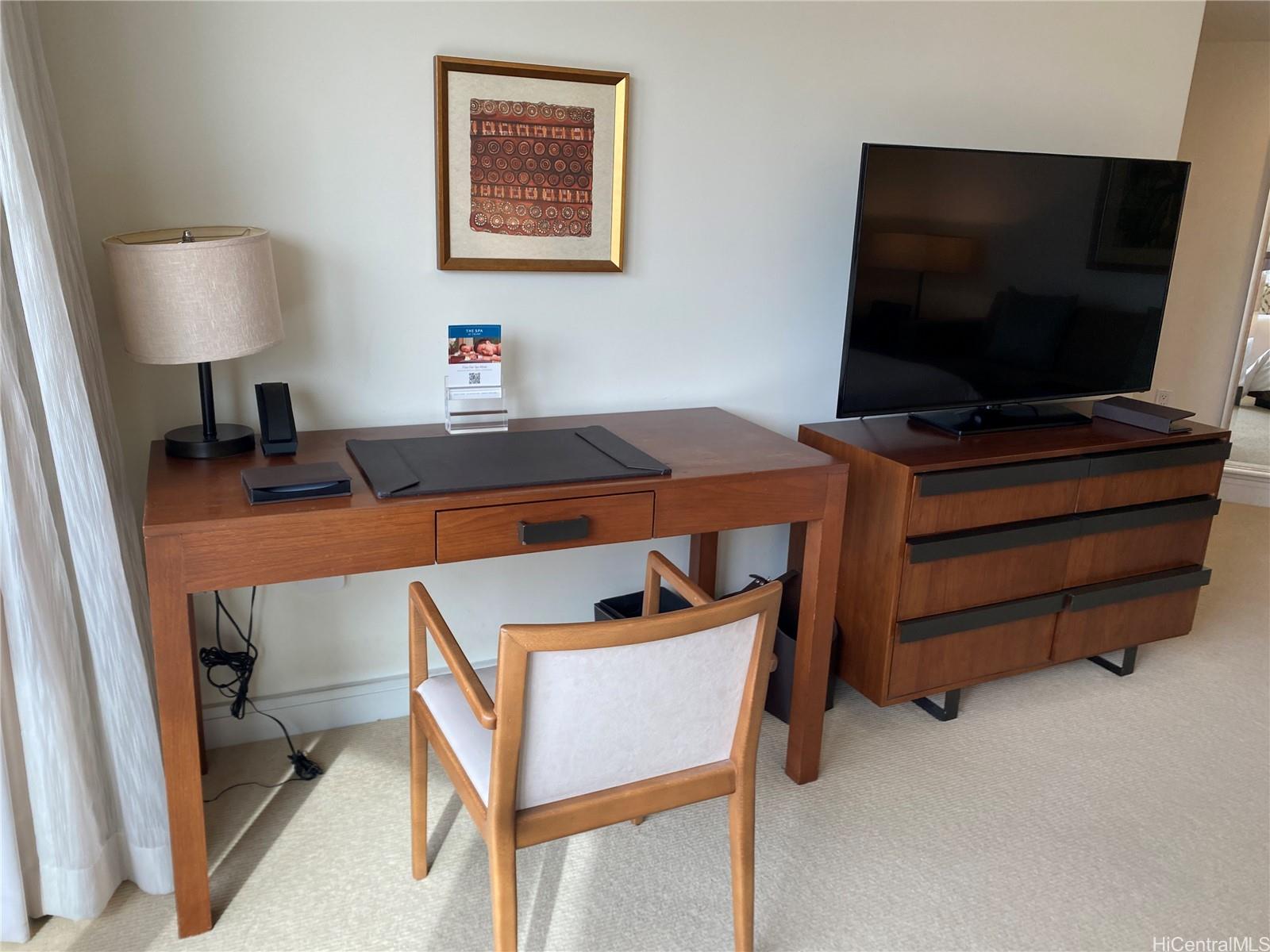 223 Saratoga Road, Unit 2220 Honolulu, HI 96815 - Photo 7 of 15 a room with furniture and a flat screen tv