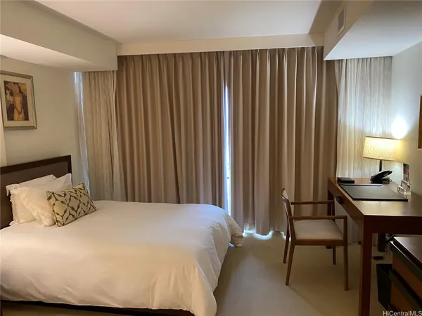 a bedroom with a bed and a table in it