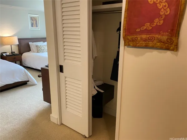 a bedroom with a bed and a cabinets