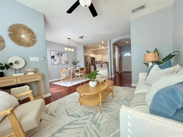 a living room with furniture and kitchen view