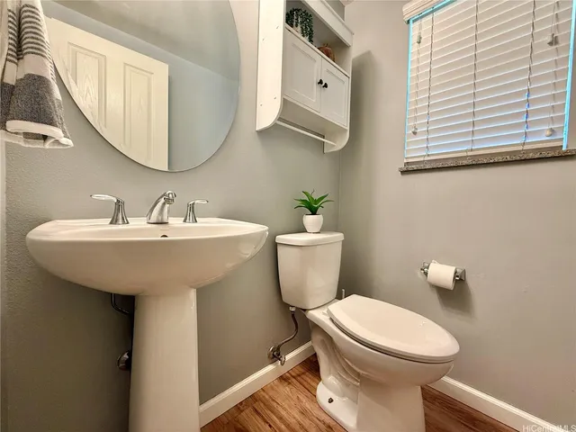 a bathroom with a sink a toilet and mirror