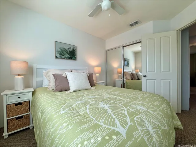 a bedroom with a bed and a lamp