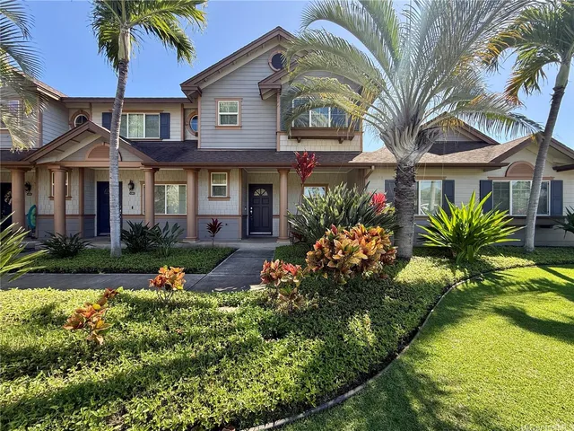 a front view of a house with a garden and swimming pool