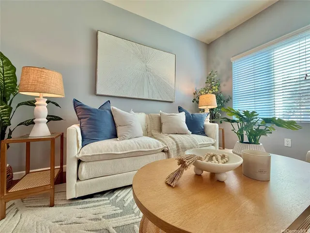 a living room with furniture and a potted plant