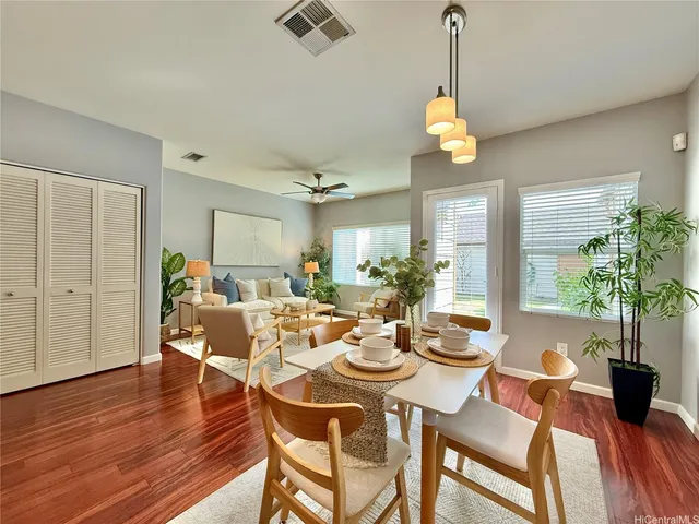 a view of a dining room with furniture window and wooden floor