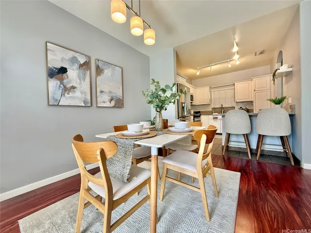 a view of a dining room with furniture and wooden floor