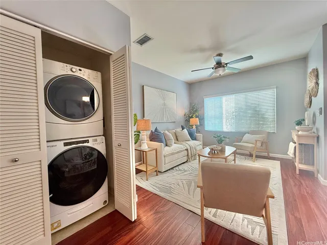 a living room with furniture a rug a fireplace and a window