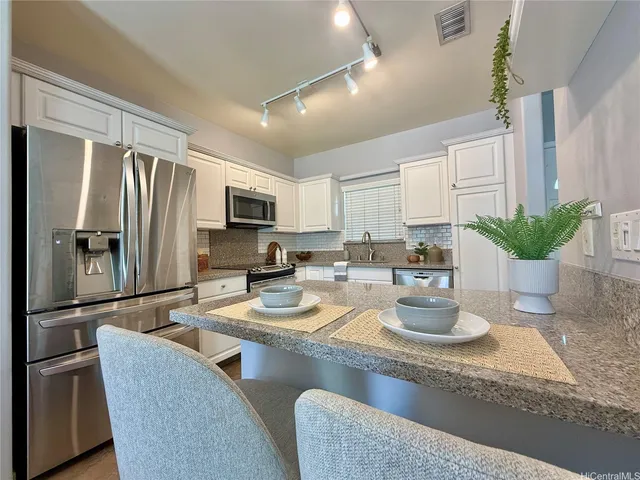 a kitchen with a refrigerator and microwave