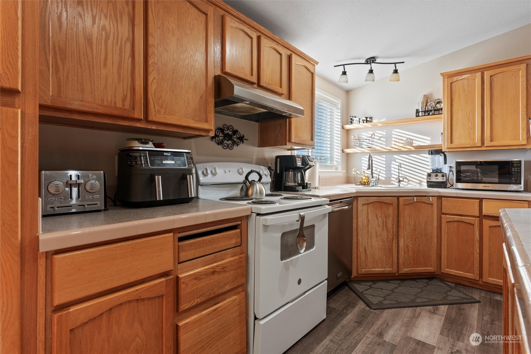 698 South Canal Road Othello, WA 99344 - Photo 21 of 40 a kitchen with stainless steel appliances granite countertop a sink a stove and cabinets