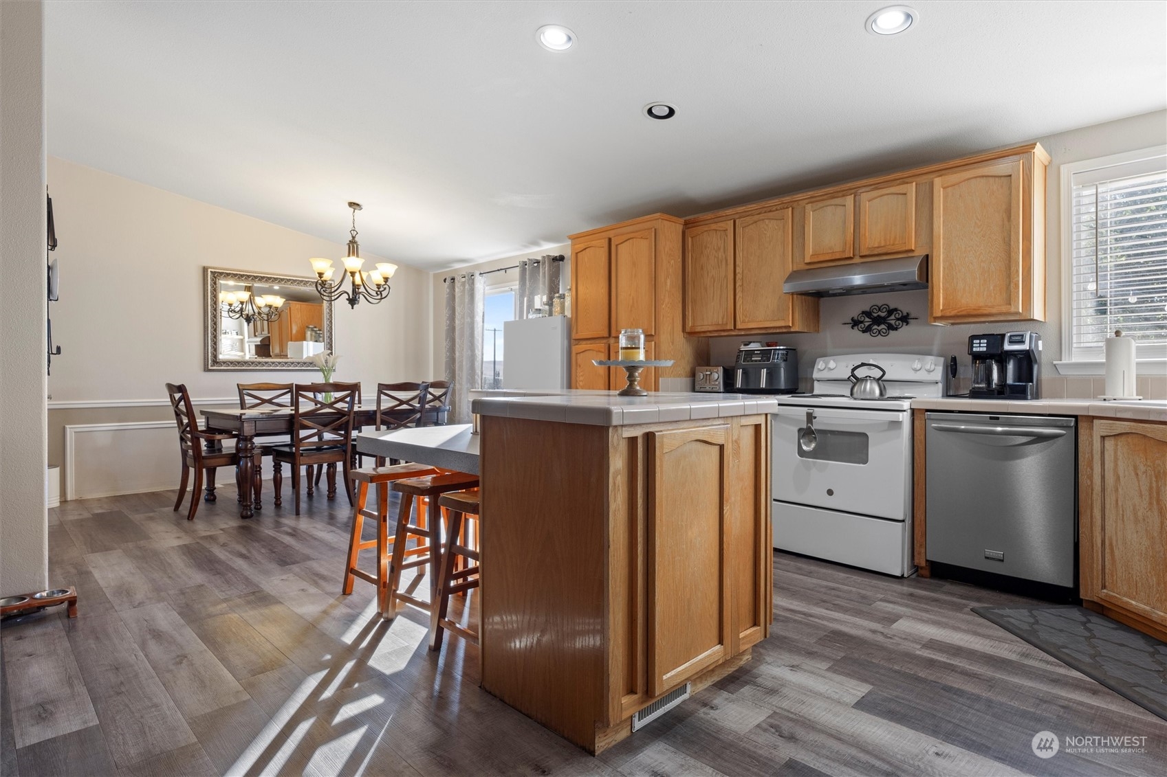 698 South Canal Road Othello, WA 99344 - Photo 23 of 40 a kitchen with a table chairs refrigerator and cabinets
