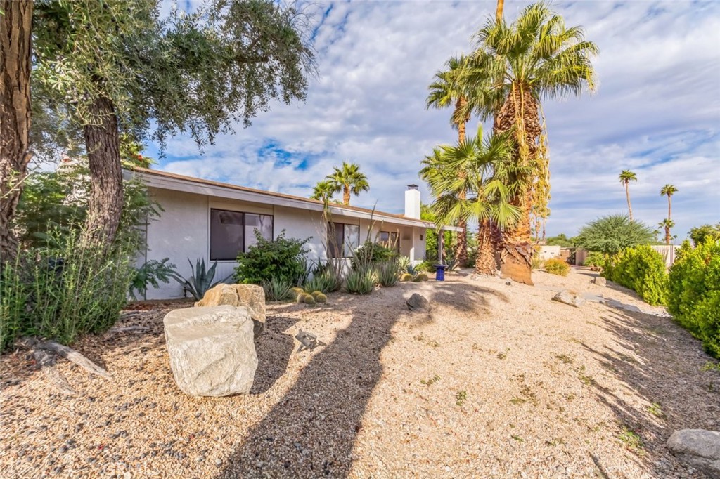 a view of a house with a yard and sitting area