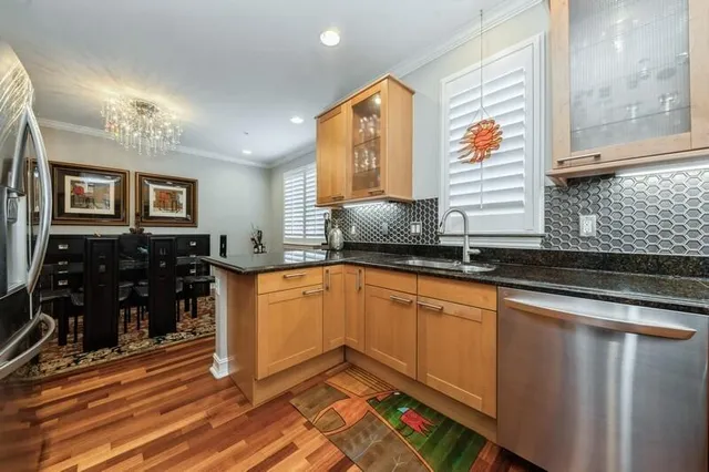 a bedroom with a bed and a flat tv screen on the dresser