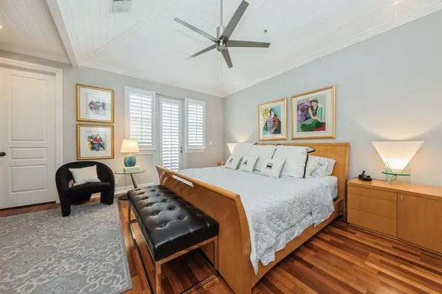 a bedroom with a bed and a flat screen tv on dresser