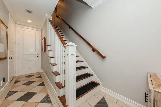 a view of a hallway with entryway and hall with wooden floor