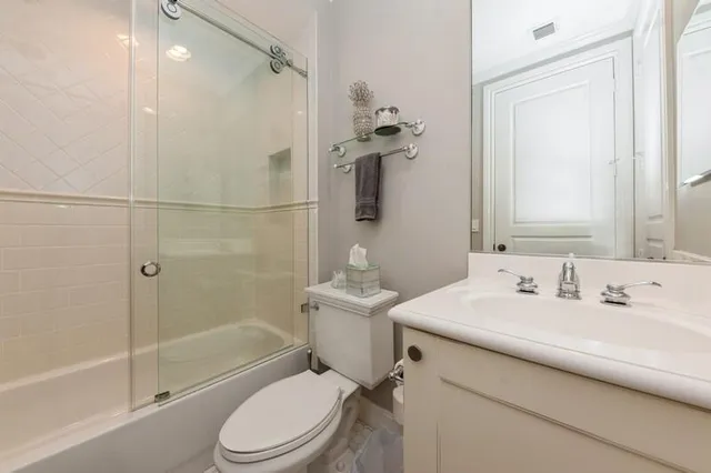 a bathroom with a sink toilet tub and shower