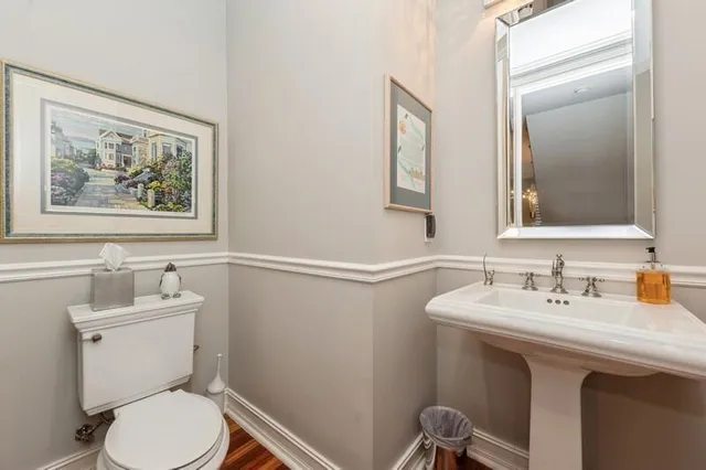 a bathroom with a toilet sink and mirror