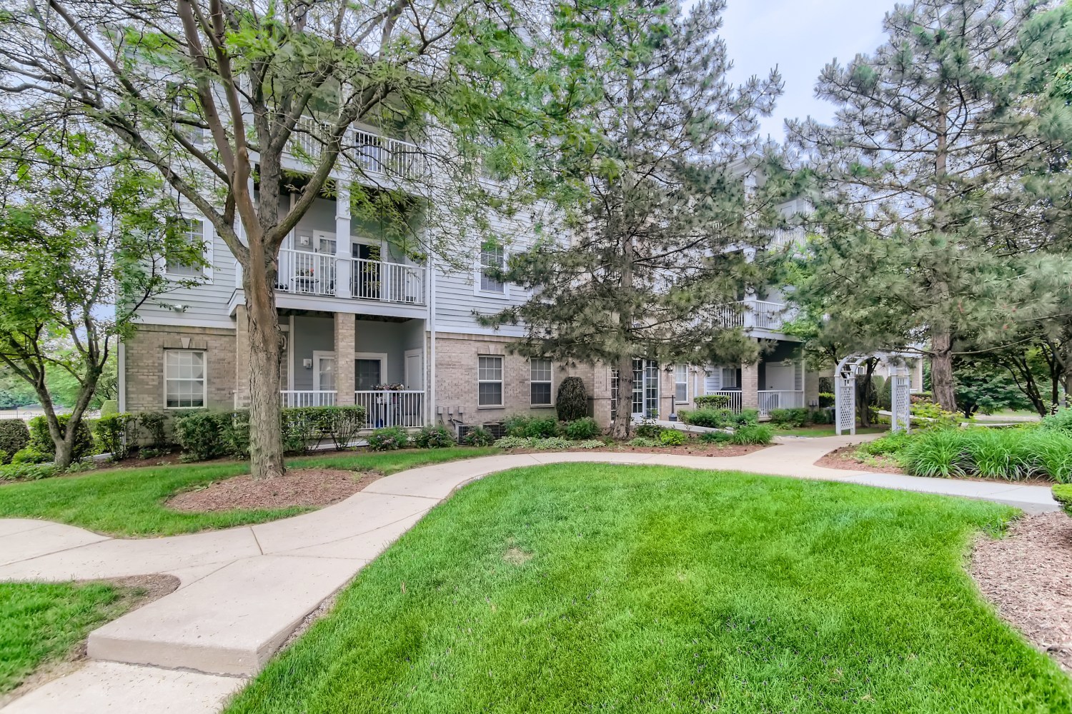 1315 Lake Street, Unit 204 Addison, IL 60101 - Photo 1 of 13 front view of a brick house with a yard