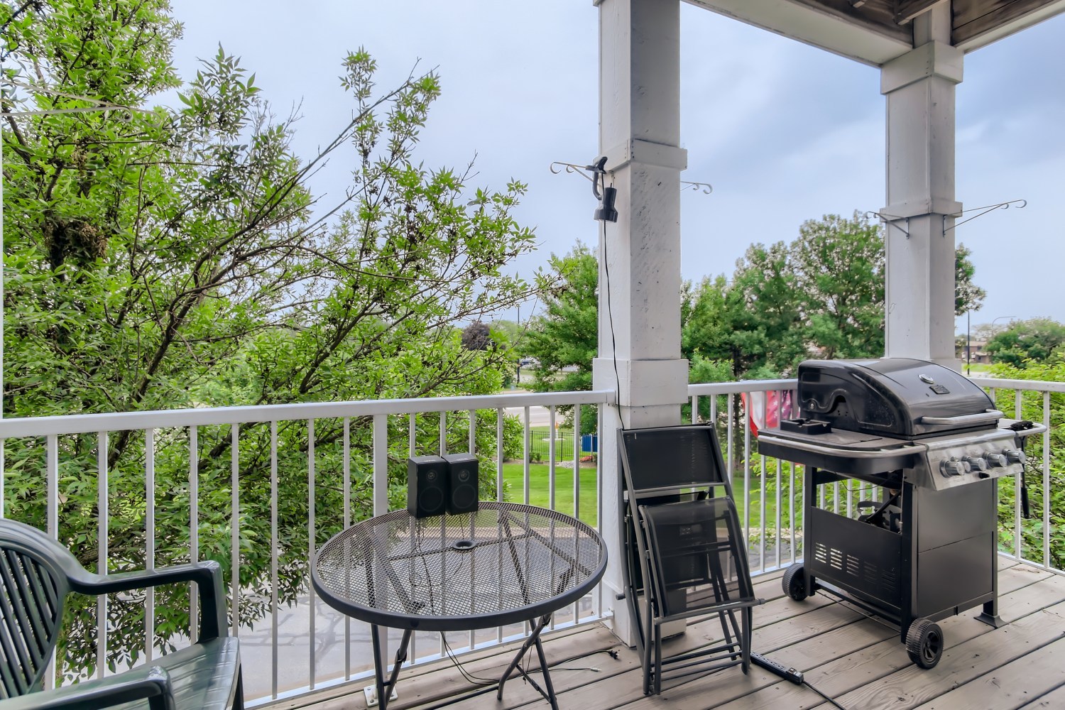 1315 Lake Street, Unit 204 Addison, IL 60101 - Photo 12 of 13 a balcony with a potted plant on a table and chairs