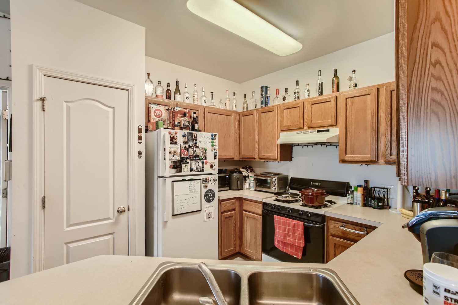 1315 Lake Street, Unit 204 Addison, IL 60101 - Photo 6 of 13 a kitchen with stainless steel appliances a refrigerator a sink a stove and white cabinets