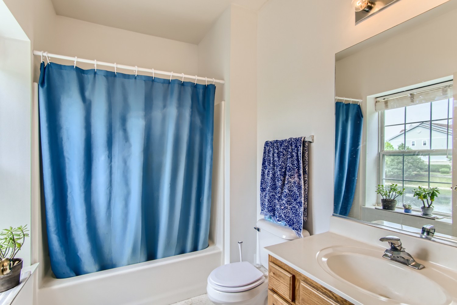 1315 Lake Street, Unit 204 Addison, IL 60101 - Photo 9 of 13 a bathroom with a sink a toilet and shower curtain