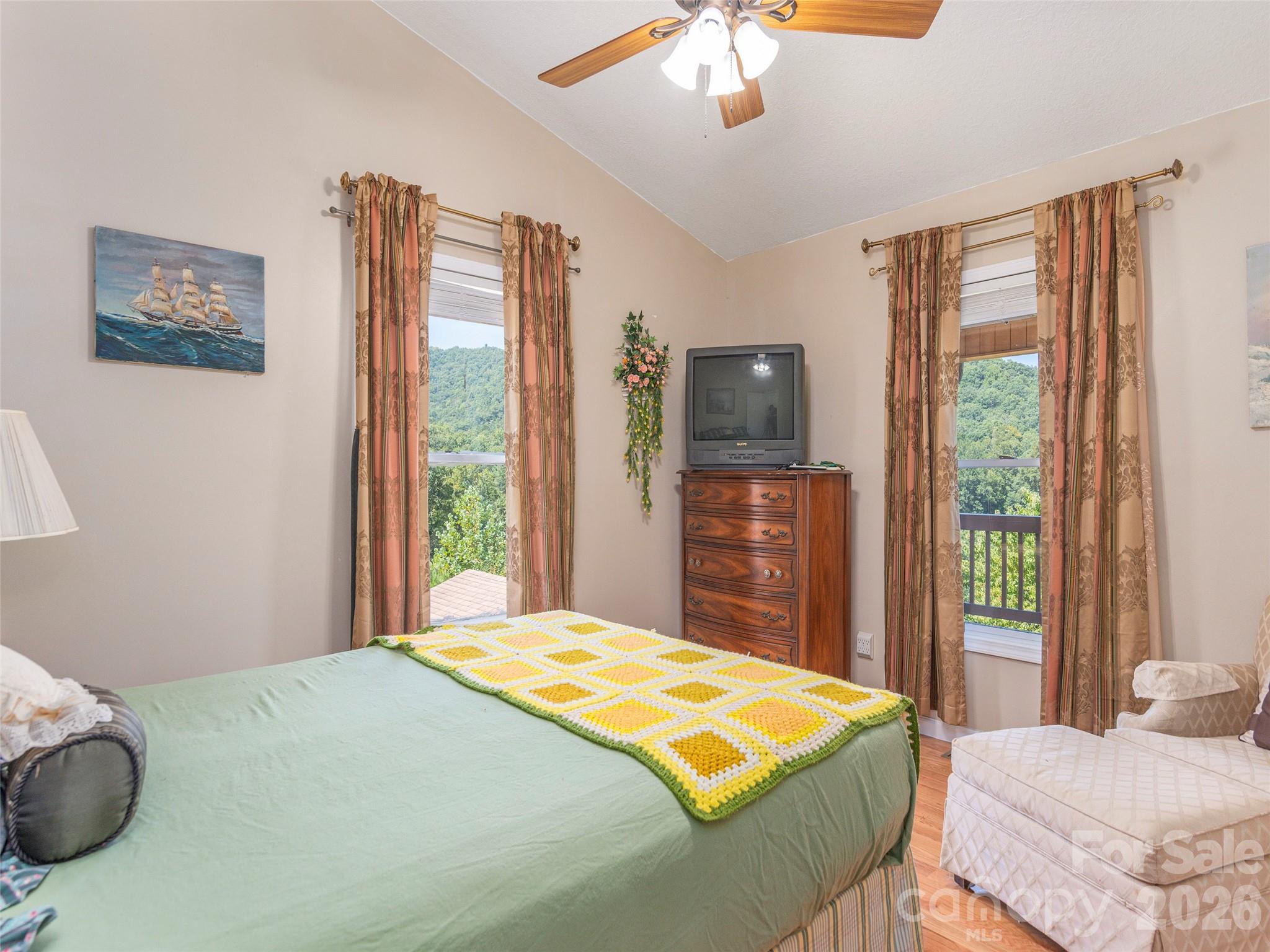 1120 Jacobs Branch Road Franklin, NC 28734 - Photo 18 of 36 a bedroom with a large bed and a flat tv screen