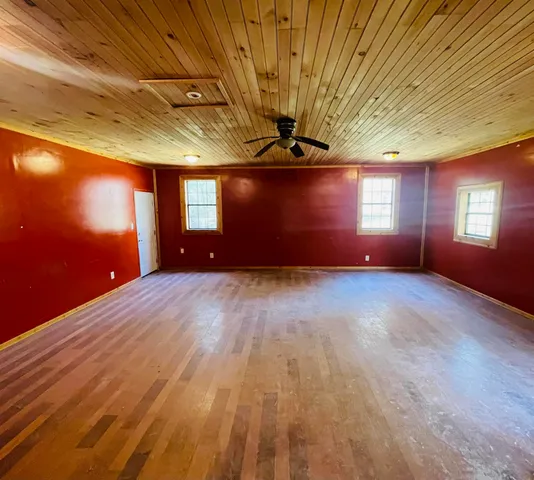 a view of wooden floor and window in a room