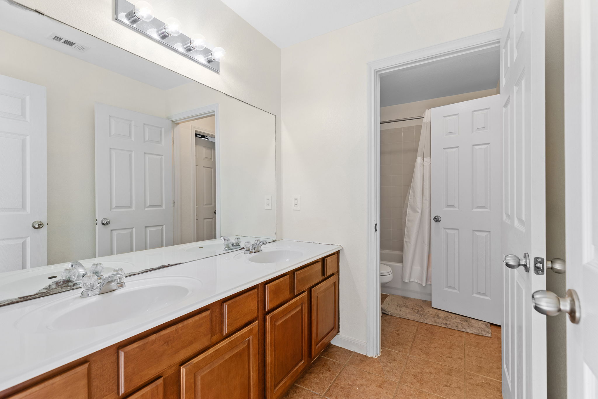 3517 Shiraz Loop Round Rock, TX 78665 - Photo 27 of 40 Double vanity with integrated sinks and wood-finish cabinetry