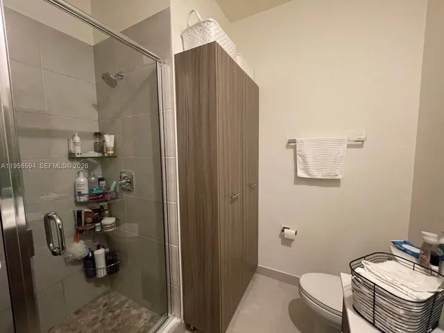 a bathroom with a sink mirror vanity and toilet