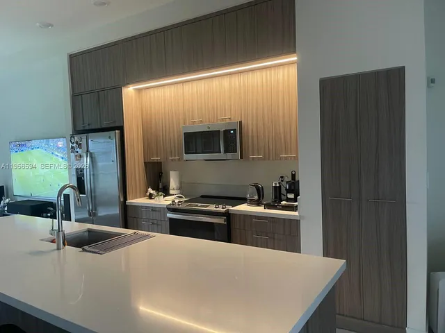 a kitchen with a stove a sink and a microwave