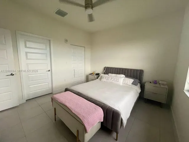 a bedroom with a bed and chair
