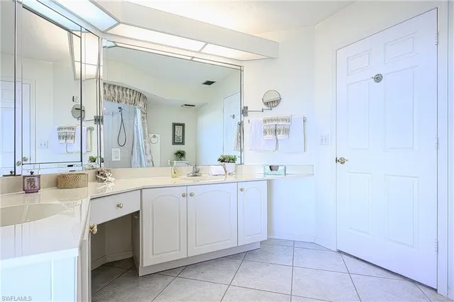 a bathroom with a sink vanity and a toilet