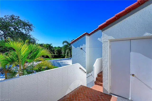 a living room with furniture and a view of kitchen
