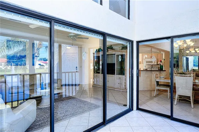 a view of a dining room with furniture a chandelier and wooden floor