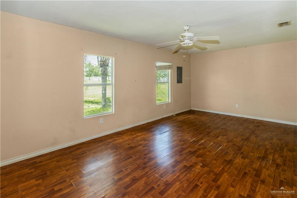 21440 Sunflower Road Edinburg, TX 78542 - Photo 5 of 25 wooden floor in an empty room with a window