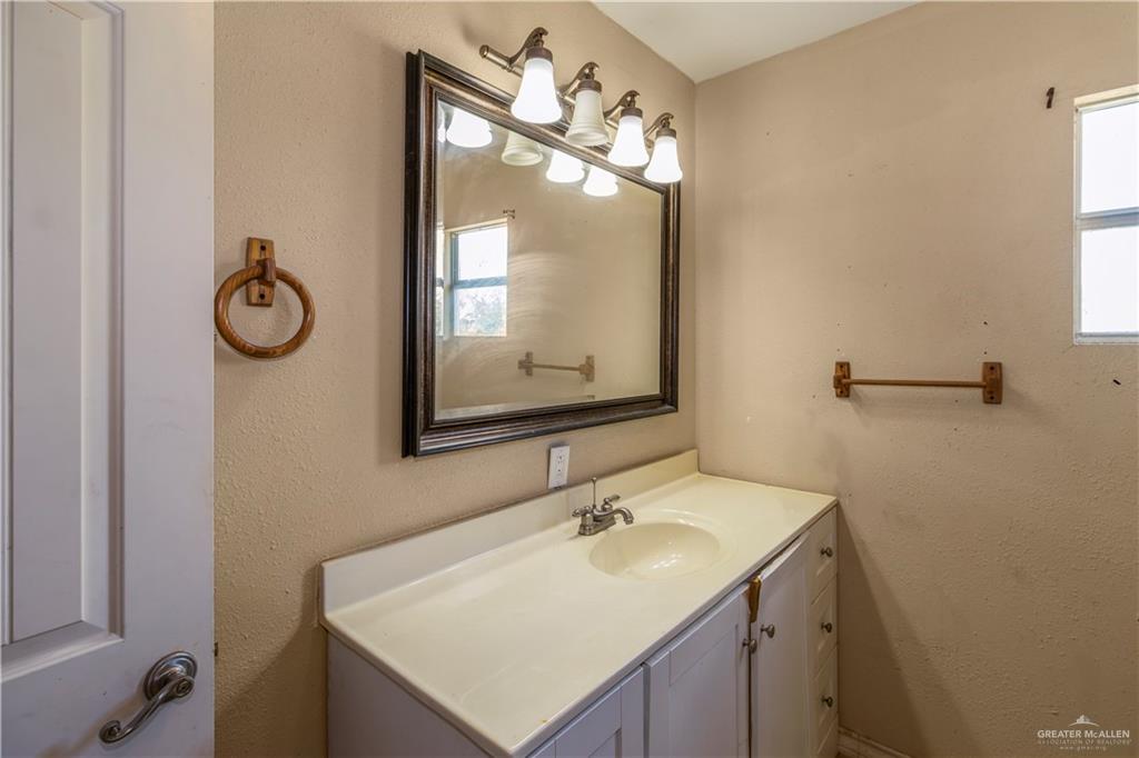 21440 Sunflower Road Edinburg, TX 78542 - Photo 7 of 25 a bathroom with a sink vanity and a mirror