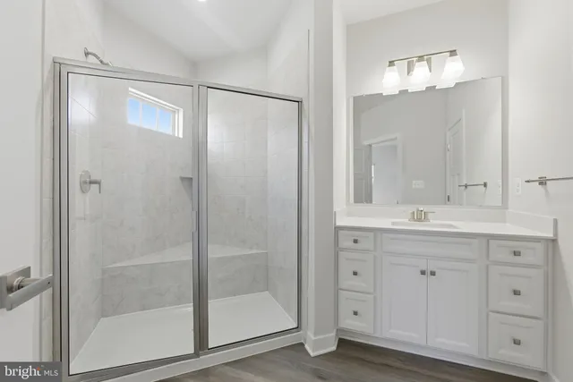 a bathroom with a shower sink and mirror