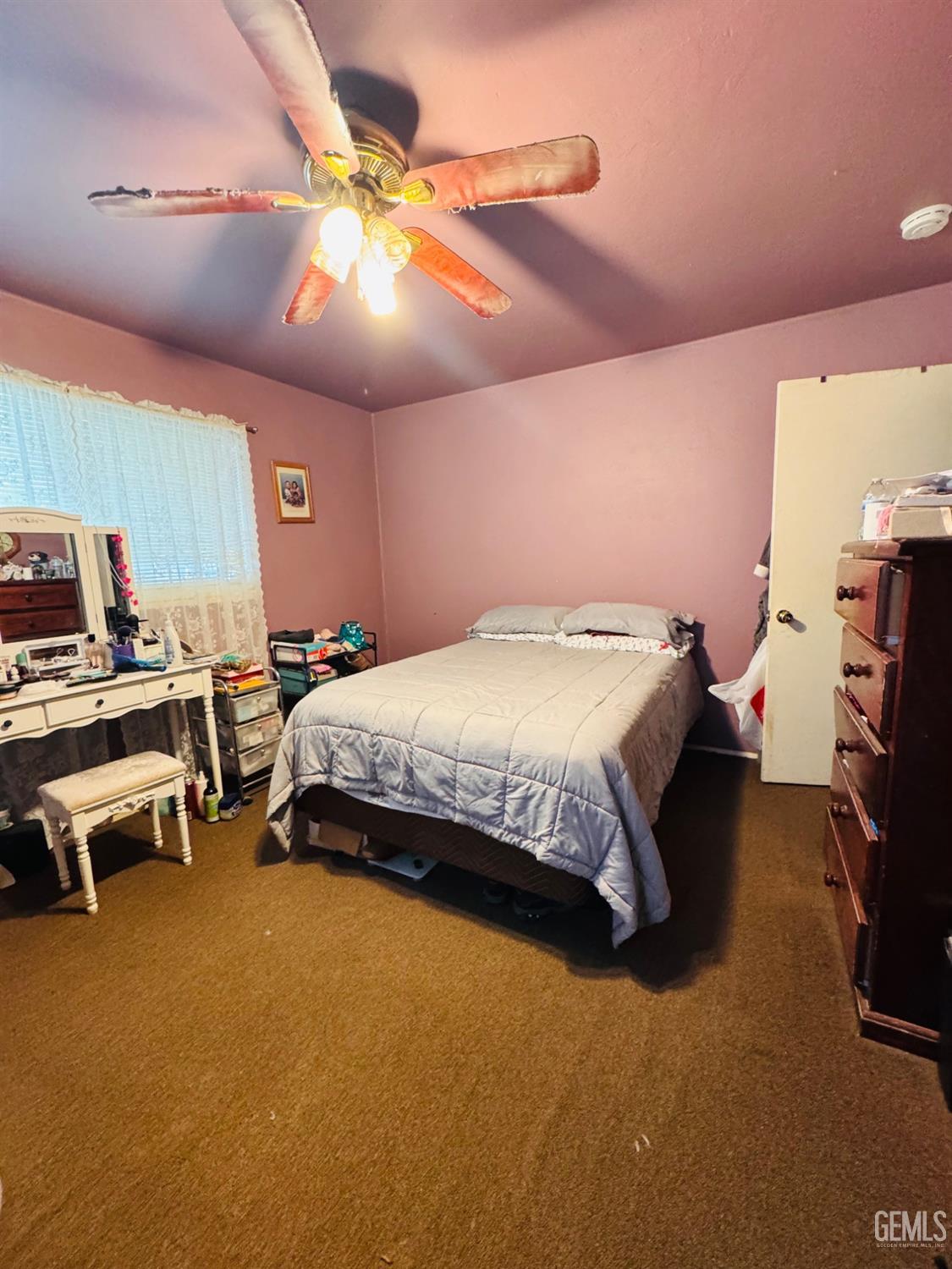 Undisclosed Address Delano, CA 93215 - Photo 11 of 18 a bedroom with a bed and a chandelier
