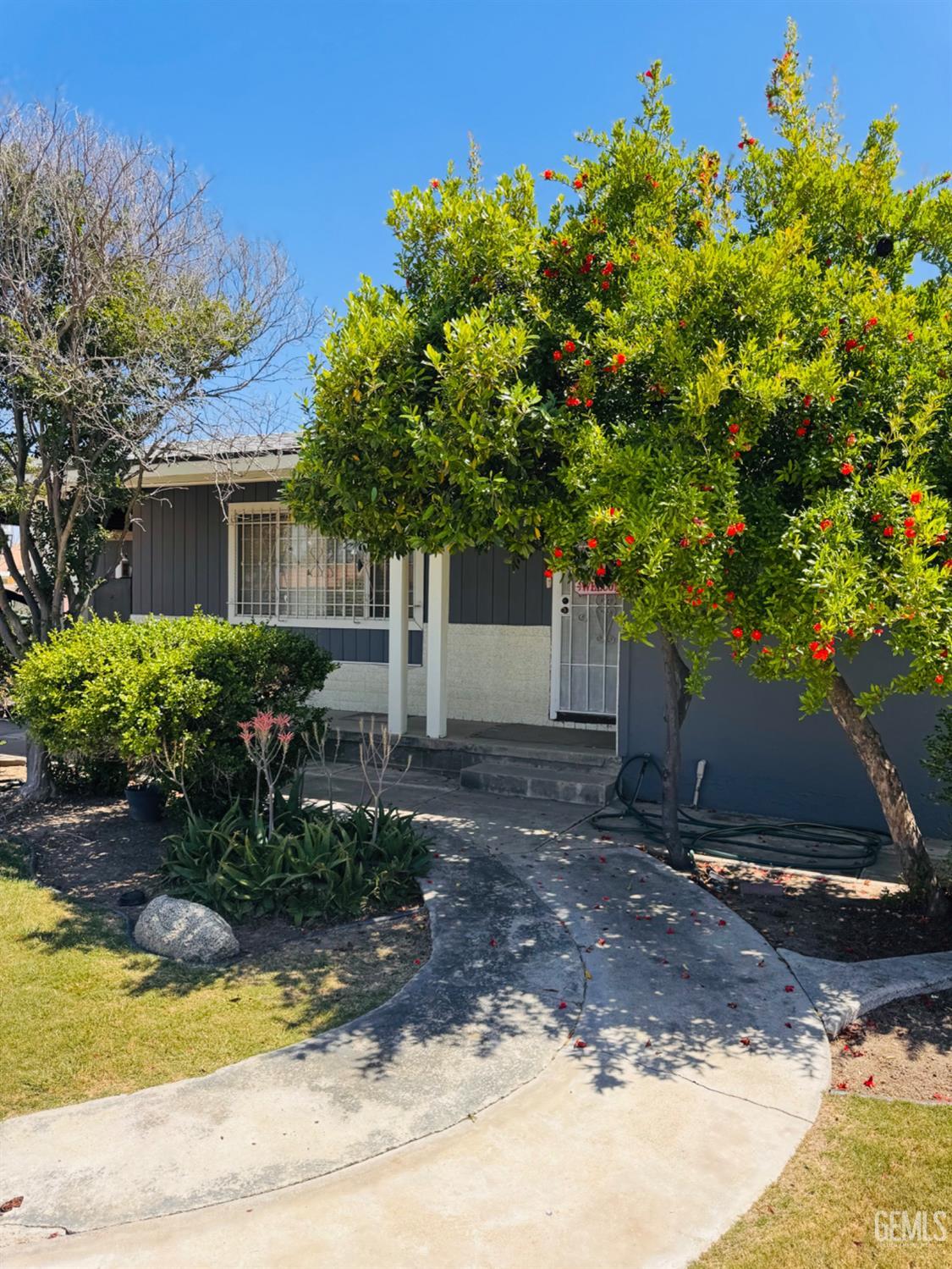 Undisclosed Address Delano, CA 93215 - Photo 4 of 18 a view of a house with a yard and a tree