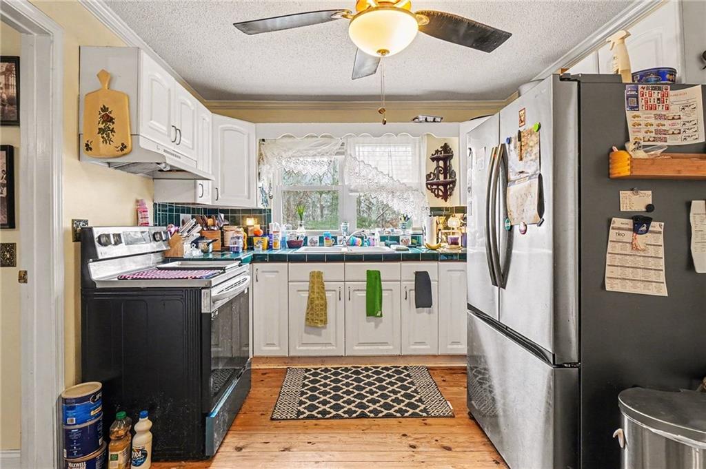 1497 Harris Road Jasper, GA 30143 - Photo 9 of 32 a kitchen with stainless steel appliances granite countertop a refrigerator and a stove