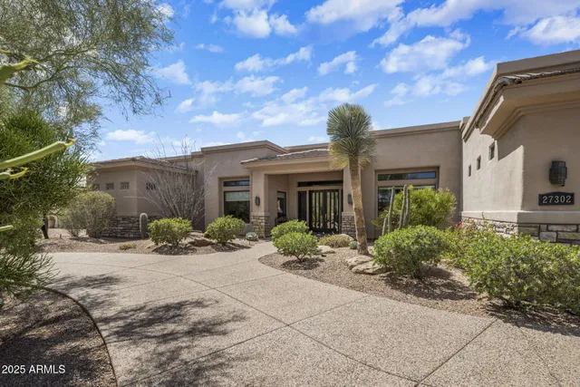 a front view of a house with yard and seating space