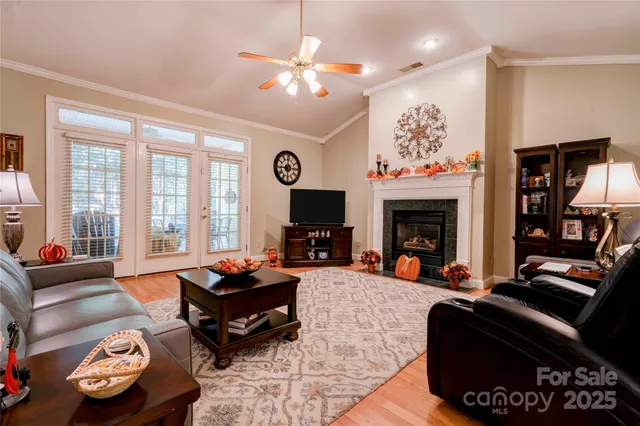 a living room with furniture a fireplace and a flat screen tv