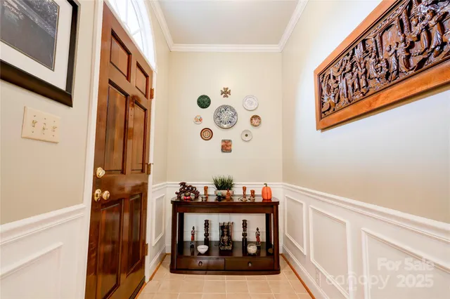 a view of living room with a baby crib and a wooden floor